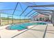 Enjoy the view from a screened pool and patio with outdoor seating and entertaining space at 7509 Hackamore Rd, Zephyrhills, FL 33541