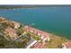 Panoramic aerial view of waterfront condos with lush landscaping and a private dock along a tranquil bay at 7520 Sunshine Skyway S Ln # 110, St Petersburg, FL 33711
