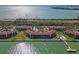 Expansive aerial view of waterfront condo community with a pool, bay access, and lush landscaping at 7520 Sunshine Skyway S Ln # 110, St Petersburg, FL 33711