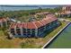 Waterfront condo complex featuring private balconies and manicured grounds with bay views on a sunny day at 7520 Sunshine Skyway S Ln # 110, St Petersburg, FL 33711