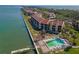 Beautiful waterfront condo complex with a pool, palm trees and pier overlooking the serene bay waters at 7520 Sunshine Skyway S Ln # 110, St Petersburg, FL 33711