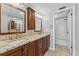 The bathroom features a double vanity, granite countertops, dark cabinetry, and a shower and tub combination at 7520 Sunshine Skyway S Ln # 110, St Petersburg, FL 33711