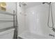 Bright bathroom features white tile, a shower and tub combo, and a chrome showerhead at 7520 Sunshine Skyway S Ln # 110, St Petersburg, FL 33711