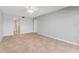 Empty bedroom features tile floors, neutral paint and access to an adjacent bathroom at 7520 Sunshine Skyway S Ln # 110, St Petersburg, FL 33711