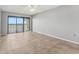The unfurnished bedroom features tile floors, neutral paint, and sliding glass doors to a balcony at 7520 Sunshine Skyway S Ln # 110, St Petersburg, FL 33711