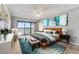 Stylishly staged bedroom features sliding glass doors to the balcony and contemporary decor at 7520 Sunshine Skyway S Ln # 110, St Petersburg, FL 33711