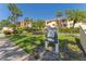 Community signage surrounded by lush greenery and palm trees at 7520 Sunshine Skyway S Ln # 110, St Petersburg, FL 33711