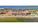 Waterfront condominium complex featuring balconies and a serene coastal setting with lush trees at 7520 Sunshine Skyway S Ln # 110, St Petersburg, FL 33711
