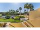 Beautifully landscaped community with lush greenery, palm trees and flowering plants at 7520 Sunshine Skyway S Ln # 110, St Petersburg, FL 33711