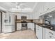 Well-lit kitchen features stainless steel appliances, light cabinetry, and tile backsplash at 7520 Sunshine Skyway S Ln # 110, St Petersburg, FL 33711
