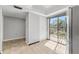 The spacious living room features tile floors, neutral paint, and sliding glass doors to the balcony at 7520 Sunshine Skyway S Ln # 110, St Petersburg, FL 33711