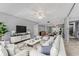 Bright living room with neutral paint, stylish decor, and access to other rooms in the home at 7520 Sunshine Skyway S Ln # 110, St Petersburg, FL 33711