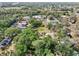 Wide aerial perspective of a neighborhood with mature trees, homes and open space at 8614 Hibiscus Dr, Tampa, FL 33637