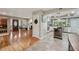 Welcoming entryway view with a stylish door and an open kitchen featuring stainless steel appliances at 8614 Hibiscus Dr, Tampa, FL 33637