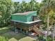 Lovely elevated home features an expansive screened-in porch area for enjoying the outdoors at 8614 Hibiscus Dr, Tampa, FL 33637