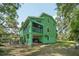 The two-story house has a large yard, an outdoor patio, balcony, and large surrounding trees at 8614 Hibiscus Dr, Tampa, FL 33637