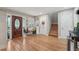 Inviting foyer featuring hardwood floors, wooden doors, and staircase to the upper level at 8614 Hibiscus Dr, Tampa, FL 33637