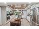 Modern kitchen with white cabinetry, stainless steel appliances, a wine cooler, and wood plank ceiling at 8614 Hibiscus Dr, Tampa, FL 33637