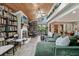 Open living room with vaulted wood ceilings, fireplace, and expansive windows showcasing the outdoor view at 8614 Hibiscus Dr, Tampa, FL 33637