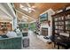 Spacious living room with a vaulted wood ceiling, fireplace, and a view to the outside at 8614 Hibiscus Dr, Tampa, FL 33637