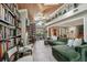 Cozy living room featuring a grand bookcase, comfortable seating, and natural light from large windows at 8614 Hibiscus Dr, Tampa, FL 33637