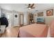 Cozy bedroom with hardwood floors, overhead fan, and bright natural lighting at 8614 Hibiscus Dr, Tampa, FL 33637