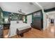 Bright bedroom with hardwood floors, ceiling fan, and a view of the hallway at 8614 Hibiscus Dr, Tampa, FL 33637