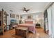Cozy bedroom with hardwood floors, overhead fan, and bright natural lighting at 8614 Hibiscus Dr, Tampa, FL 33637
