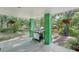 The spacious covered outdoor patio has a grill and is surrounded by beautiful trees and greenery at 8614 Hibiscus Dr, Tampa, FL 33637