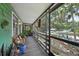 Screened-in porch featuring wooden flooring and railings with a seating area and view at 8614 Hibiscus Dr, Tampa, FL 33637