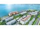 Expansive aerial view of waterfront condos featuring lush landscaping, parking, and stunning bay views at 9 Haig Pl # 510, Dunedin, FL 34698