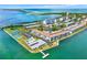 Breathtaking aerial view highlighting waterfront condos with a pool, surrounded by scenic bay views at 9 Haig Pl # 510, Dunedin, FL 34698