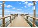 Scenic view of a private dock with weathered wood and blue sky, perfect for waterfront living and recreational boating at 9 Haig Pl # 510, Dunedin, FL 34698