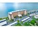 An aerial view reveals a condo complex with waterfront views, covered parking, and verdant landscaping at 9 Haig Pl # 510, Dunedin, FL 34698