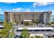 Exterior of the building featuring a covered parking area, well maintained landscaping, and waterfront views at 9 Haig Pl # 510, Dunedin, FL 34698