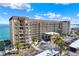 Exterior of the building featuring scaffolding, beautiful landscaping, and waterfront views from multiple floors at 9 Haig Pl # 510, Dunedin, FL 34698