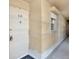 Hallway entrance to unit 510 with beige walls and a decorative door knocker at 9 Haig Pl # 510, Dunedin, FL 34698