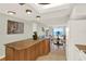 Open-concept kitchen featuring a breakfast bar and a view of the living area with stunning ocean views at 9 Haig Pl # 510, Dunedin, FL 34698