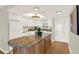Bright kitchen with a large island, white cabinets, modern appliances, and ample counter space at 9 Haig Pl # 510, Dunedin, FL 34698