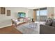Inviting living room featuring modern furniture, wood floors, and balcony access with water views at 9 Haig Pl # 510, Dunedin, FL 34698