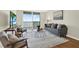 Bright living room with sliding door to a balcony with a water view, modern furnishings, and wood flooring at 9 Haig Pl # 510, Dunedin, FL 34698