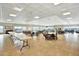 Spacious meeting room with tables, chairs, fireplace and water view windows at 9 Haig Pl # 510, Dunedin, FL 34698
