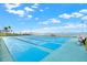 Shuffleboard courts overlooking waterfront view with benches for relaxation at 9 Haig Pl # 510, Dunedin, FL 34698