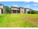 Expansive backyard featuring a well-maintained lawn and mature landscaping at 10617 Lucaya Dr, Tampa, FL 33647