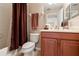 Well-lit bathroom with a shower-tub combination, wood vanity, and modern fixtures at 10617 Lucaya Dr, Tampa, FL 33647