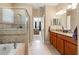 This bathroom features a separate tub and shower with neutral tile at 10617 Lucaya Dr, Tampa, FL 33647