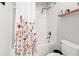 Bathroom with a shower-tub combination and a floral shower curtain at 10617 Lucaya Dr, Tampa, FL 33647