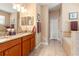Double vanities and lots of tile make this bathroom shine at 10617 Lucaya Dr, Tampa, FL 33647