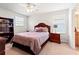 Comfortable bedroom featuring a wooden bed frame, coordinating nightstands, and natural light at 10617 Lucaya Dr, Tampa, FL 33647