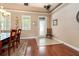 Elegant dining room with hardwood floors, tray ceiling, and ample natural light from large windows at 10617 Lucaya Dr, Tampa, FL 33647